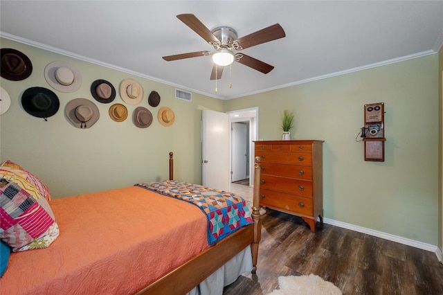 bedroom with dark wood-type flooring, ornamental molding, and ceiling fan