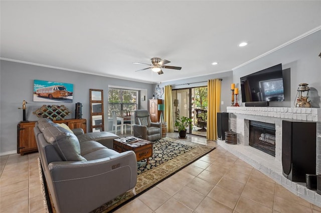 living room featuring a wealth of natural light, a brick fireplace, and light tile patterned floors