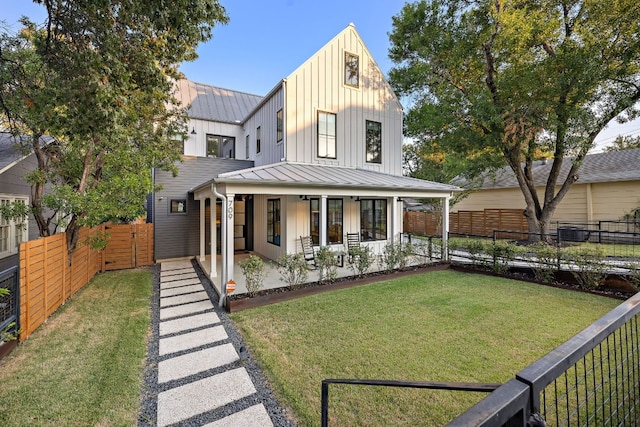 modern inspired farmhouse with a porch and a front yard