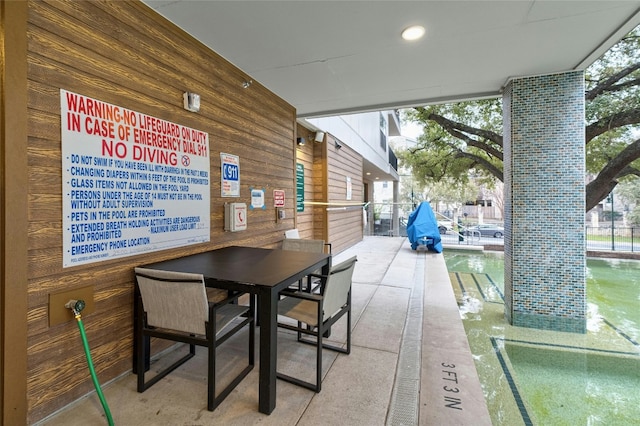 dining room with wooden walls