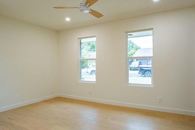 spare room featuring light hardwood / wood-style floors and ceiling fan