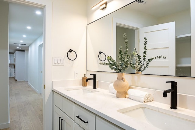 bathroom featuring hardwood / wood-style flooring and vanity