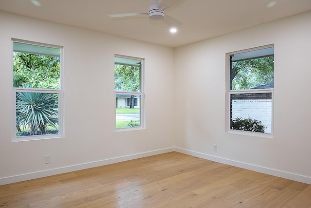 empty room with light hardwood / wood-style floors and ceiling fan