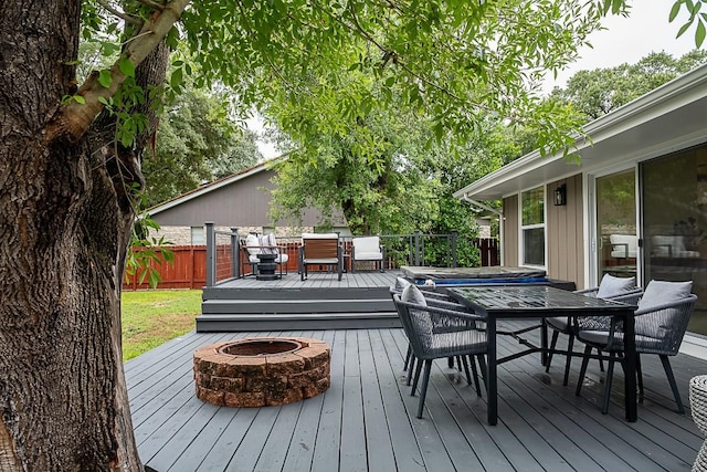 wooden deck featuring an outdoor fire pit