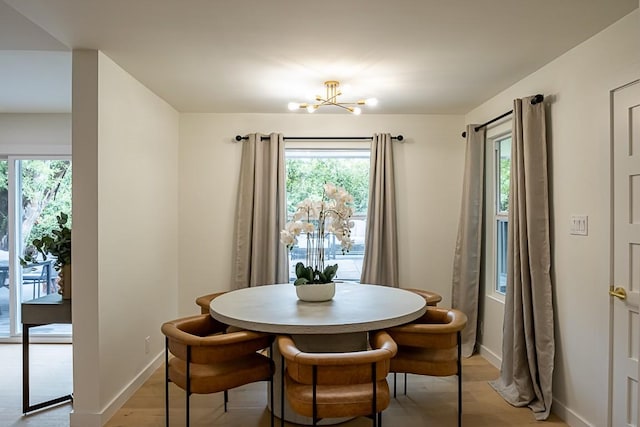 dining room with an inviting chandelier and light hardwood / wood-style floors