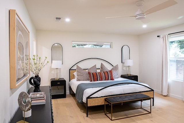 bedroom with light hardwood / wood-style floors and ceiling fan