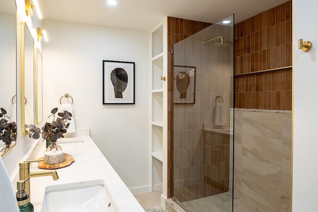 bathroom with vanity and a tile shower