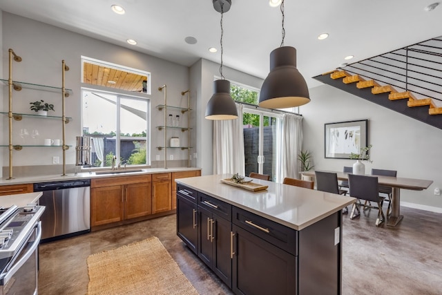 kitchen featuring pendant lighting, sink, range, a kitchen island, and stainless steel dishwasher