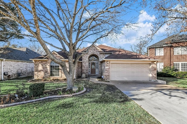 view of front of property featuring a garage and a front lawn