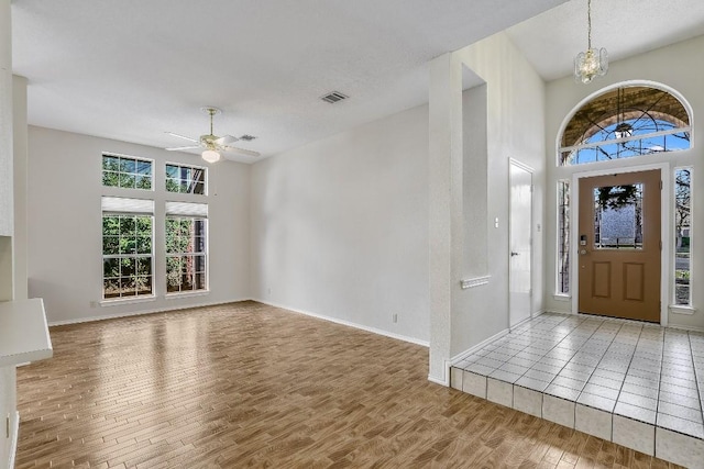 1212 Dove Cir, Cedar Park, TX 78613 - entrance foyer featuring wood finished floors, a ceiling fan, a chandelier, and baseboards