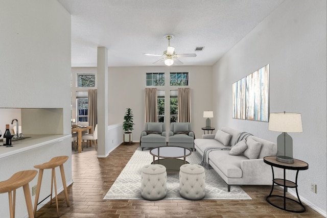 living room featuring ceiling fan and dark hardwood / wood-style flooring