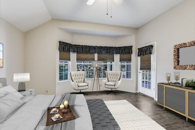 living room with dark wood-type flooring, ceiling fan, and vaulted ceiling