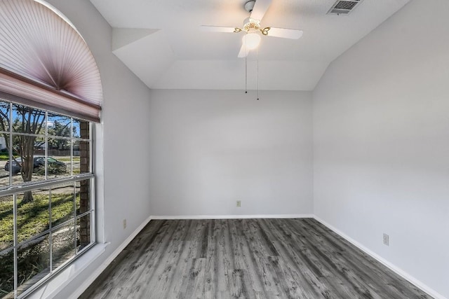 spare room featuring lofted ceiling, dark wood-type flooring, and ceiling fan