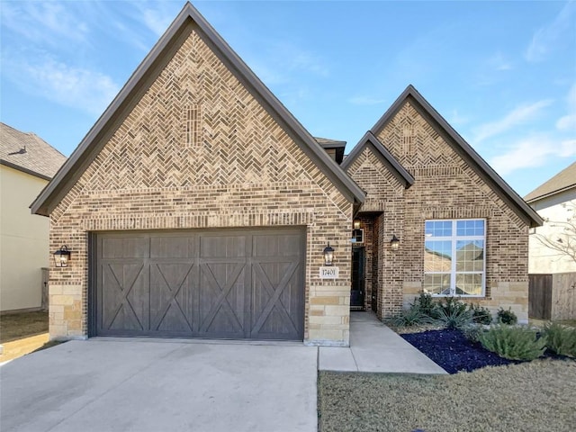 17401 Howdy Way, Manor, TX 78653 - french country home featuring brick siding, concrete driveway, and a garage