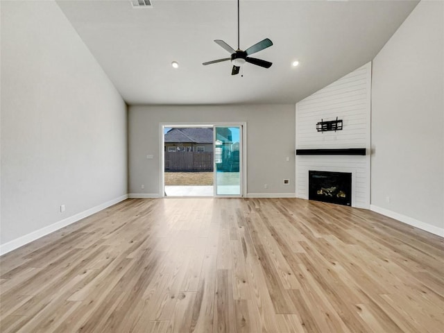 17401 Howdy Way, Manor, TX 78653 - unfurnished living room with lofted ceiling, ceiling fan, light wood-style flooring, a fireplace, and baseboards