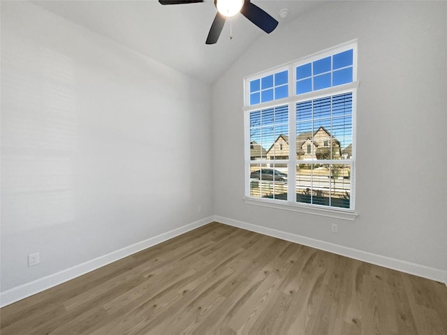 17401 Howdy Way, Manor, TX 78653 - unfurnished room featuring ceiling fan, baseboards, wood finished floors, vaulted ceiling, and a smoke detector