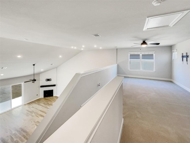 17401 Howdy Way, Manor, TX 78653 - corridor featuring baseboards, lofted ceiling, recessed lighting, and light colored carpet