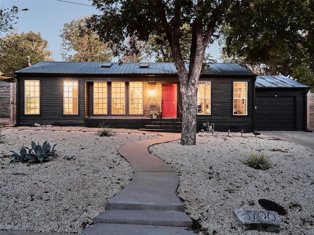 ranch-style home featuring a garage