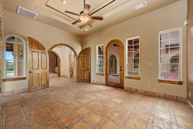 interior space with ceiling fan