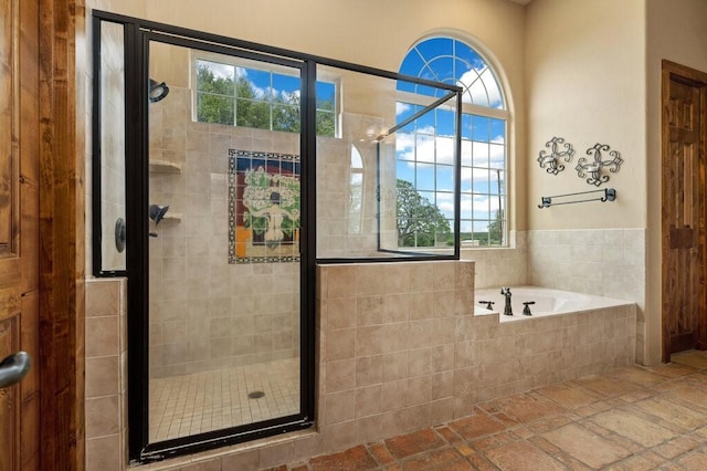 bathroom featuring separate shower and tub