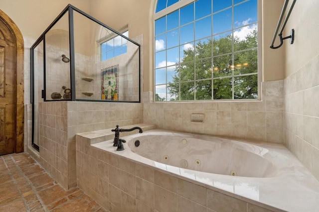 bathroom featuring independent shower and bath