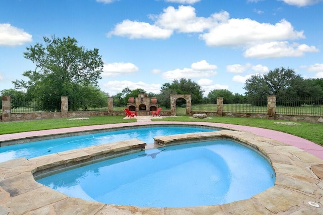 view of swimming pool with a fireplace and an in ground hot tub