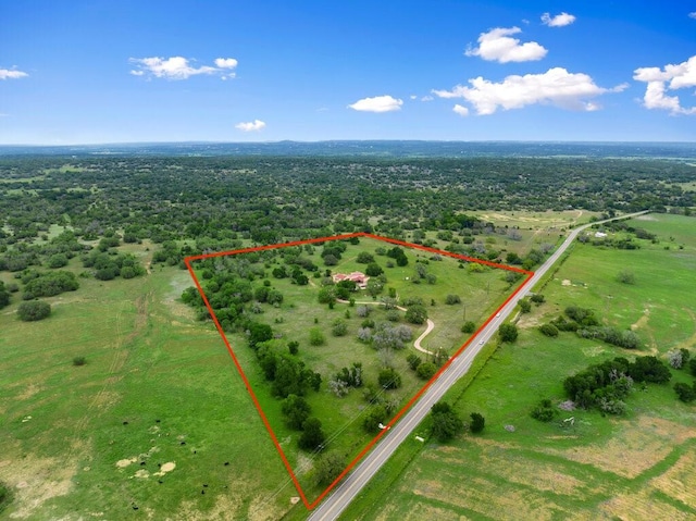 birds eye view of property with a rural view