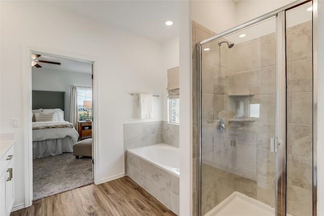 bathroom with wood-type flooring, independent shower and bath, and plenty of natural light