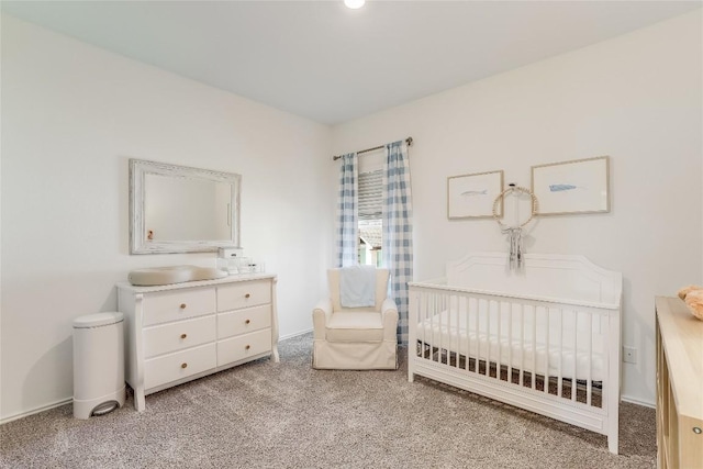 bedroom with a crib and light colored carpet