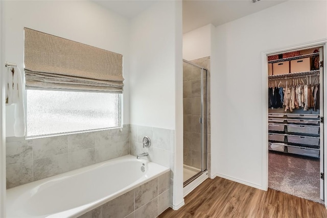 bathroom with wood-type flooring and separate shower and tub