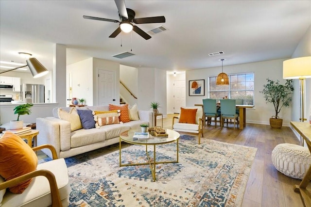 living room featuring hardwood / wood-style flooring and ceiling fan