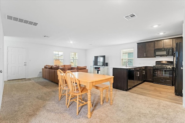 carpeted dining room featuring sink