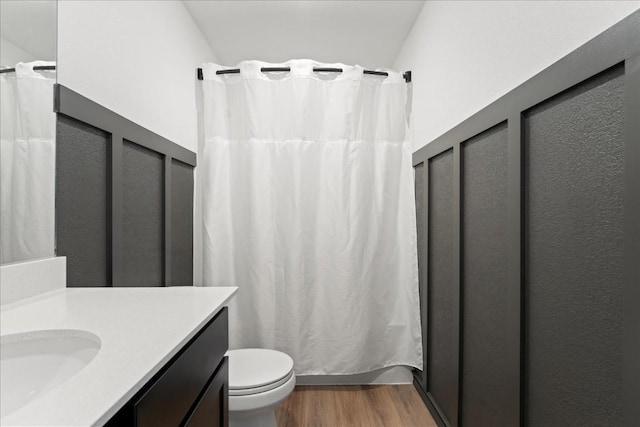 bathroom featuring vanity, hardwood / wood-style floors, toilet, and walk in shower