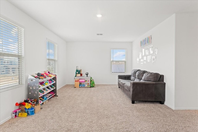 recreation room featuring light colored carpet