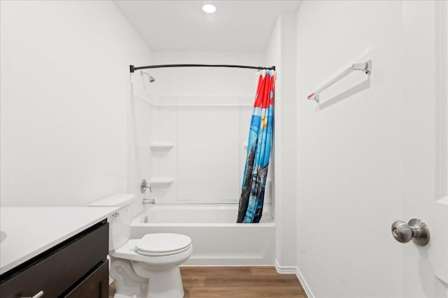 full bathroom featuring vanity, hardwood / wood-style flooring, toilet, and shower / bath combo with shower curtain