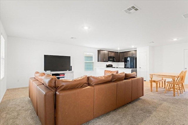 living room featuring light carpet