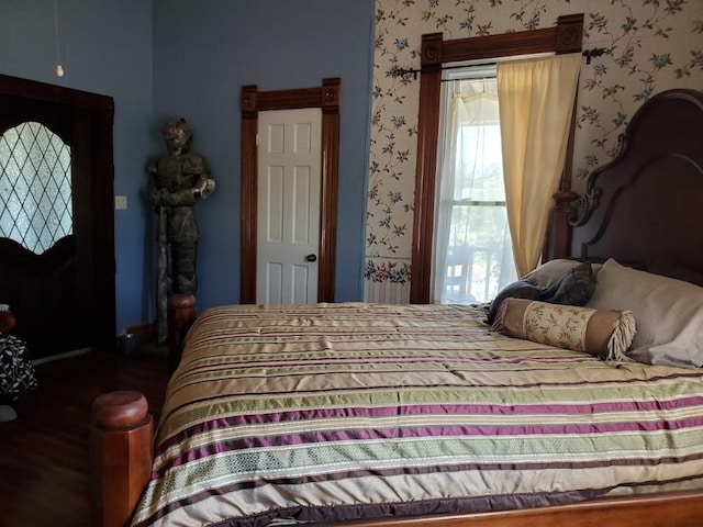 1307 Wright St, Llano, TX 78643 - bedroom with wallpapered walls and wood finished floors
