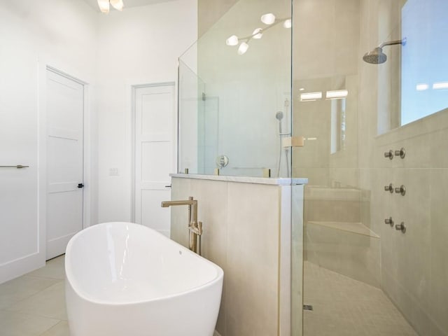 bathroom with tile patterned floors and separate shower and tub