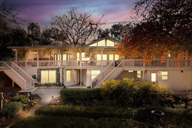 back house at dusk with a patio area