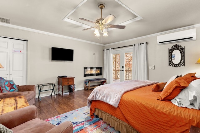 bedroom with ornamental molding, a closet, a wall unit AC, ceiling fan, and access to exterior