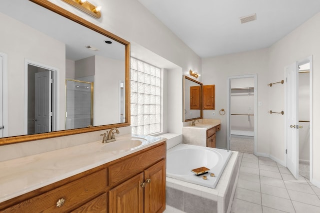 bathroom featuring vanity, tile patterned flooring, and plus walk in shower