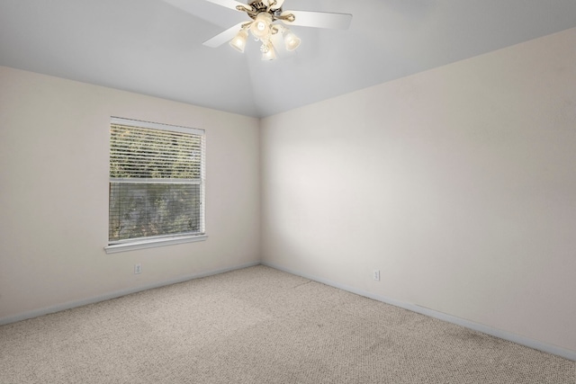 carpeted empty room with vaulted ceiling and ceiling fan