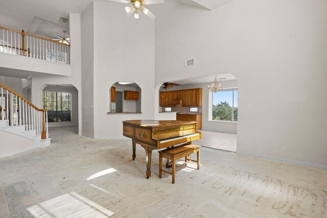 702 Timarron Dr, Leander, TX 78641 - living room featuring ceiling fan, arched walkways, high vaulted ceiling, stairs, and a chandelier