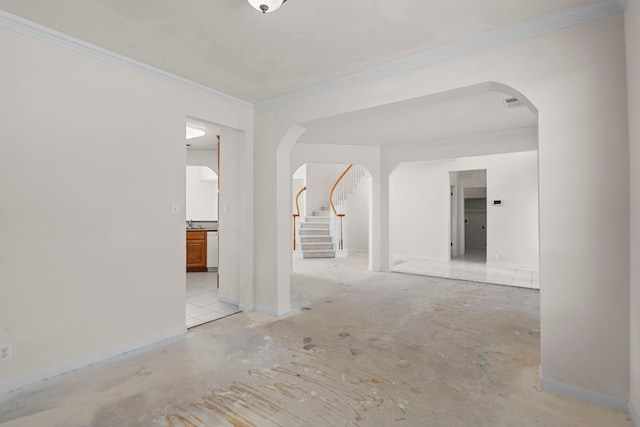 702 Timarron Dr, Leander, TX 78641 - empty room with arched walkways, stairway, and crown molding