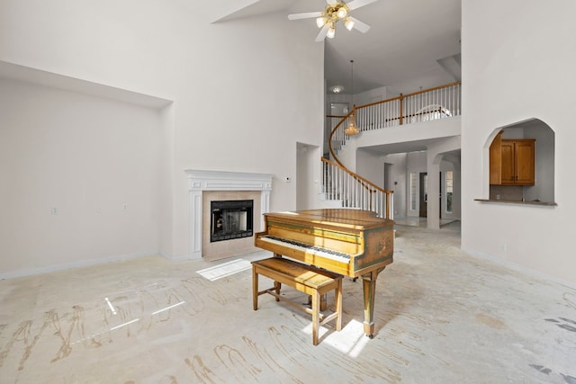 702 Timarron Dr, Leander, TX 78641 - living area featuring high vaulted ceiling, ceiling fan, a fireplace, stairs, and arched walkways