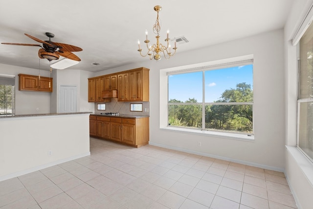 702 Timarron Dr, Leander, TX 78641 - kitchen featuring brown cabinetry, plenty of natural light, and a ceiling fan