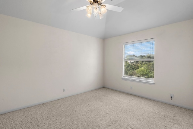 carpeted empty room featuring lofted ceiling and ceiling fan