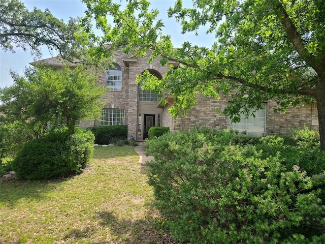 702 Timarron Dr, Leander, TX 78641 - view of front of home featuring brick siding and a front yard