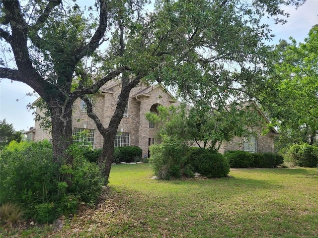 702 Timarron Dr, Leander, TX 78641 - view of property exterior featuring brick siding and a lawn