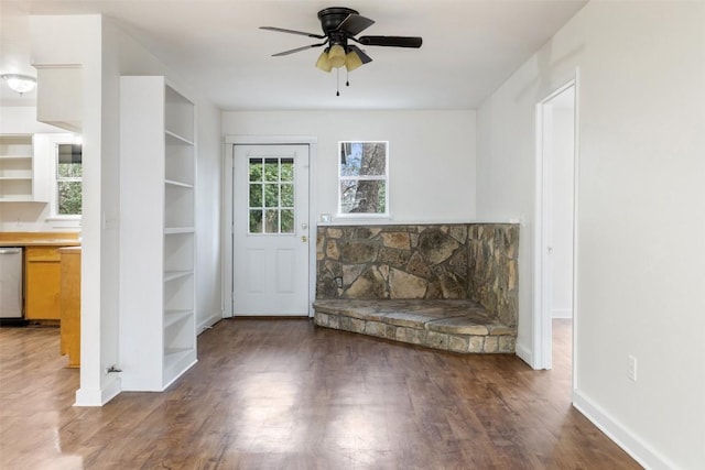 unfurnished living room with dark hardwood / wood-style floors and ceiling fan